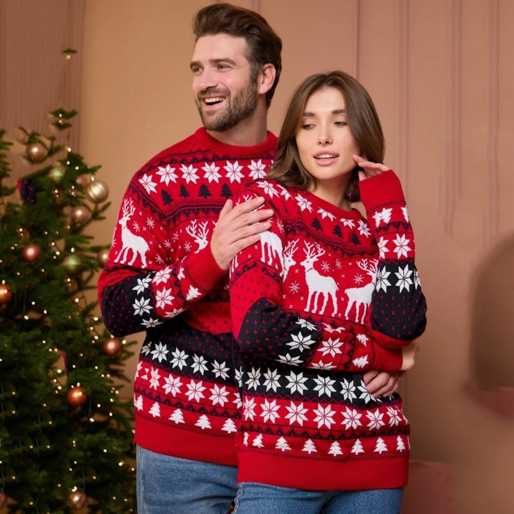 Cosy couple in knitted Christmas jumper with red and black reindeer design