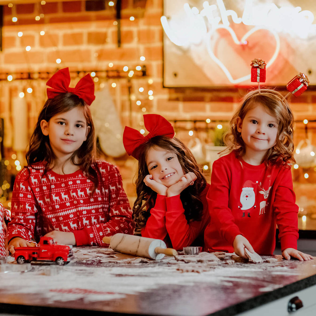 3 Daughters happily matching Christmas Pyjamas and accessories 