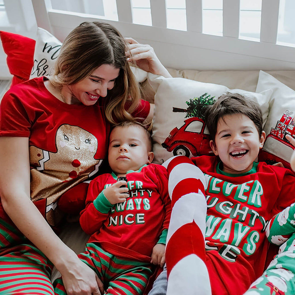 Family with a baby in matching Christmas pyjamas